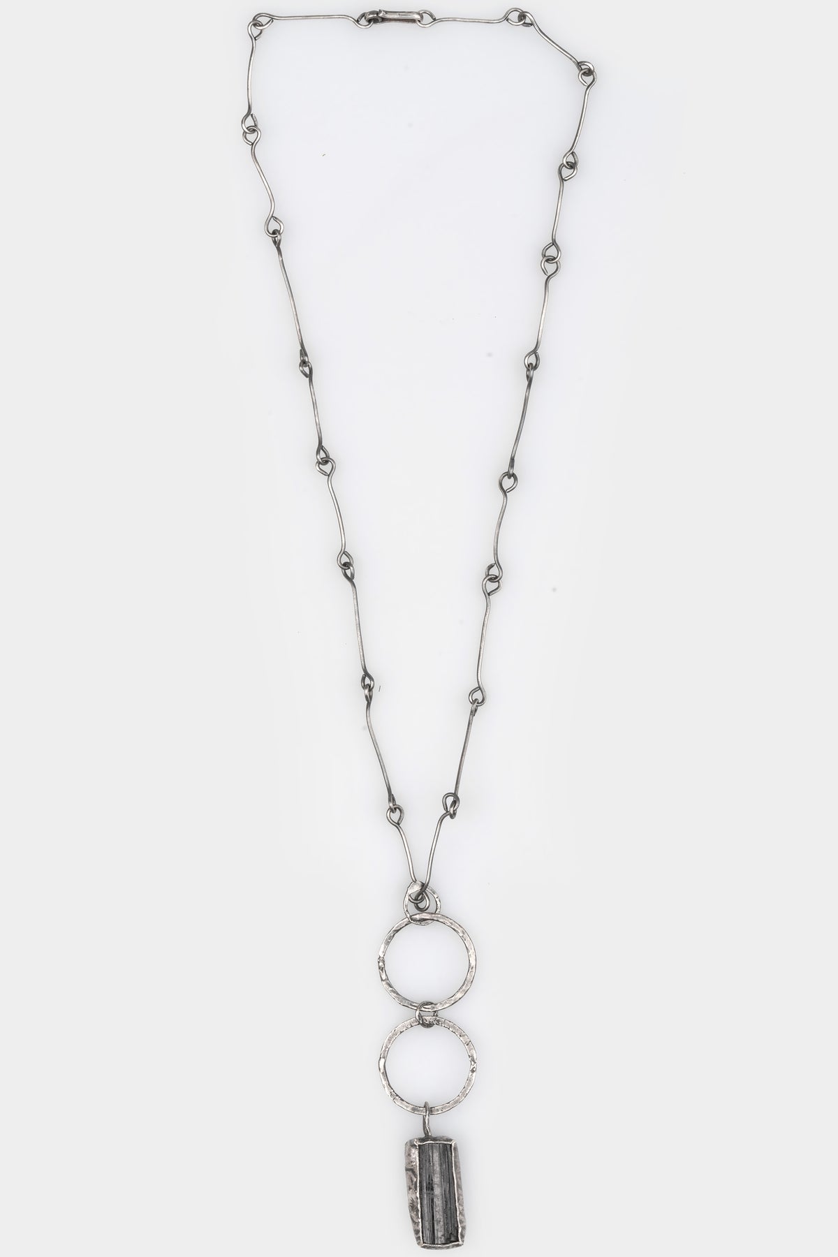 CUMA | Silver Necklace with Tourmaline pendant, shot on table